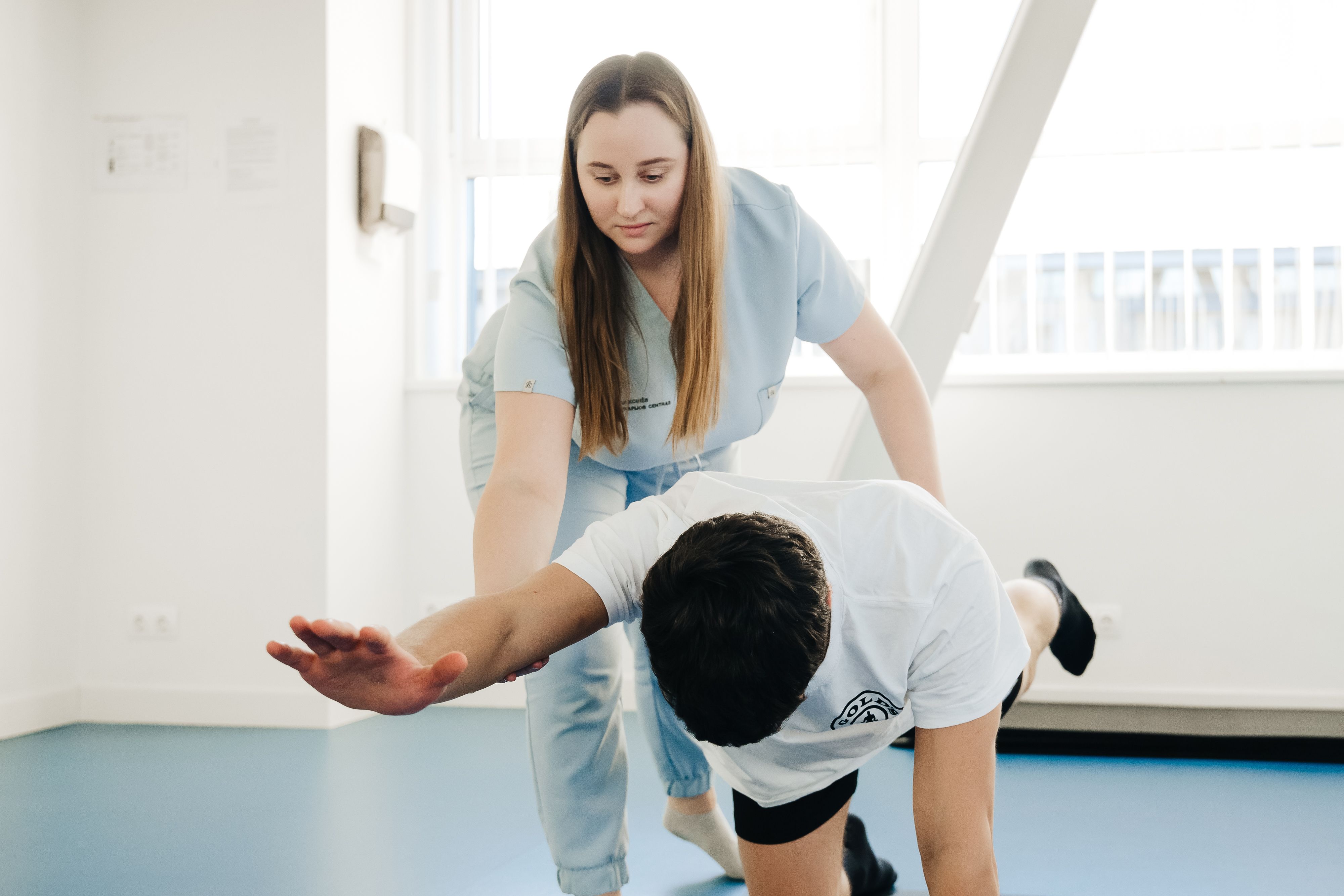Physical therapist assisting a patient through an exercise